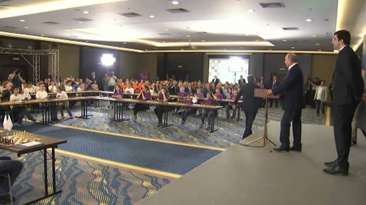A conference hall with people at tables