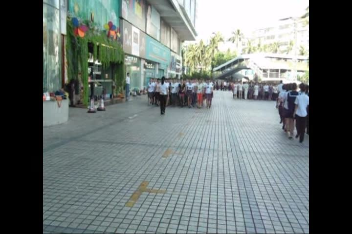 A shopping street with people walking